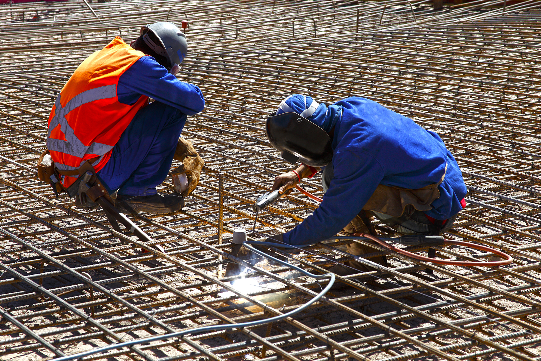 Two construction workers working