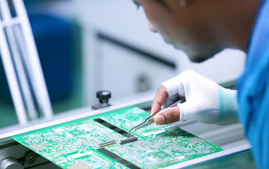 Man working on a circuitboard in a technology factory