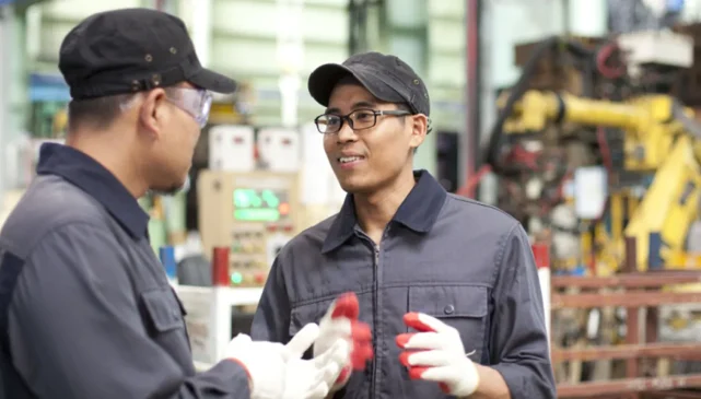 Two factory workers talking