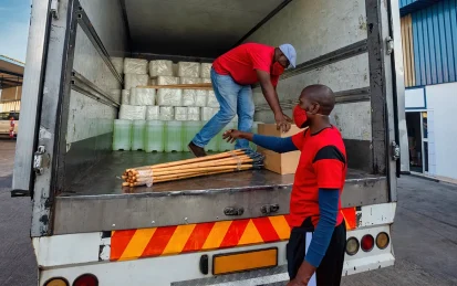 Two men loading products off the back of a lorry