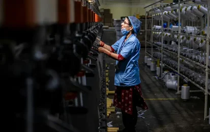 A woman working in a textile factory at night