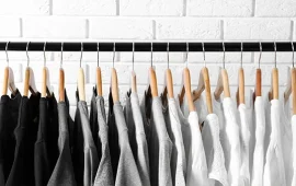 A row of t-shirts on a clothes rail
