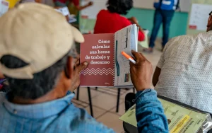 Man in a training session holding a learning document