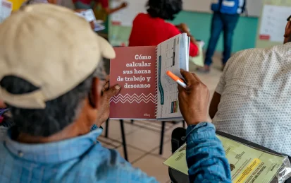 Man in a training session holding a learning document