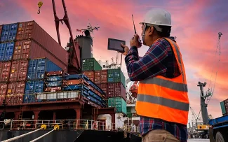 Worker in a shipping container yard