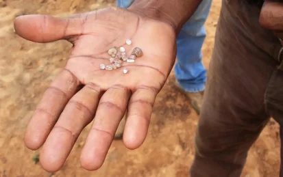 Small diamonds in a miner's hand