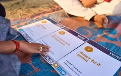Safe Tips worker guidance in India: Two people sat on the floor looking at resources