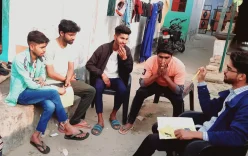 Using safe tips handbooks in the community in India: A group of young men sat together with a trainer